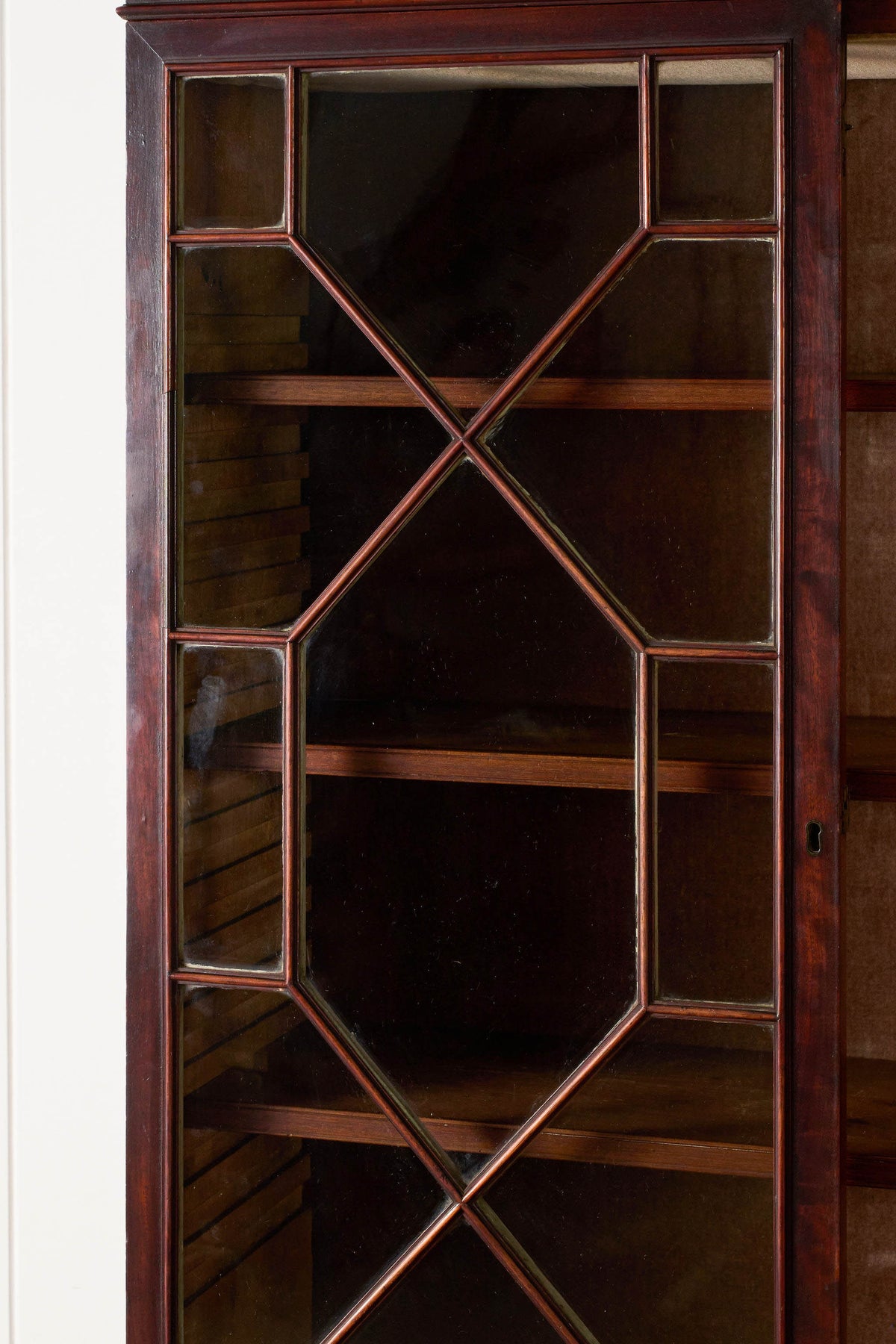 George III Mahogany Glass front Bookcase With Brushing Slide And Greek Key Pediment