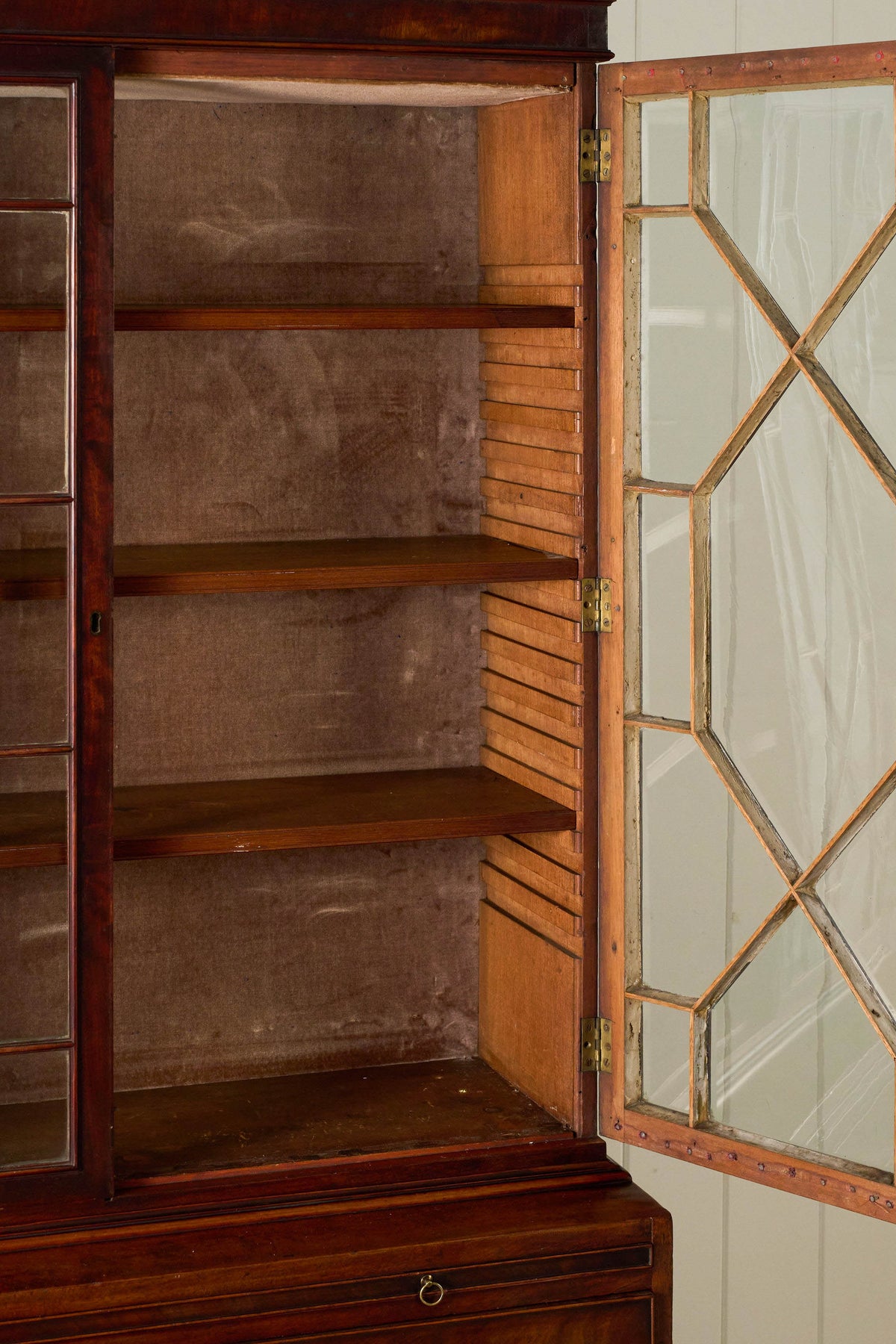 George III Mahogany Glass front Bookcase With Brushing Slide And Greek Key Pediment