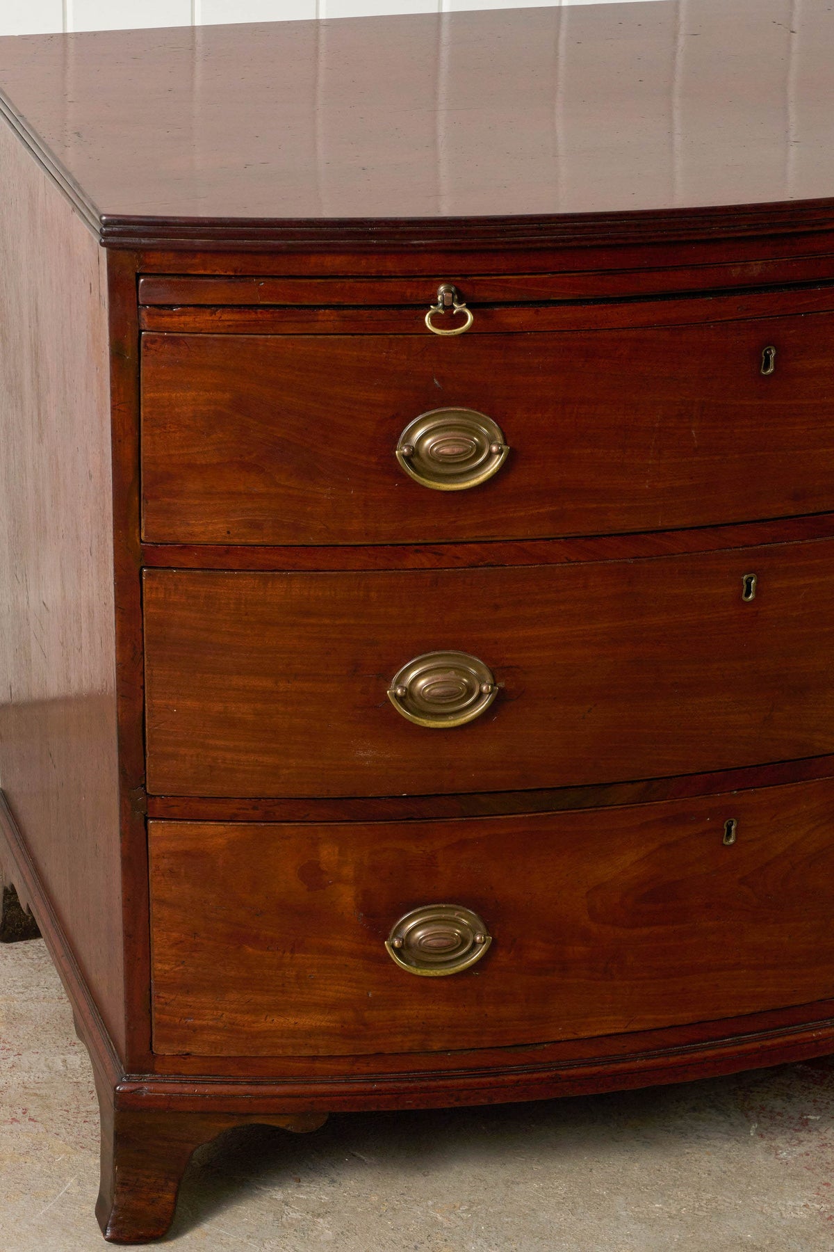 19th Century English Mahogany Bowfront 3-Drawer Chest with Brushing Slide