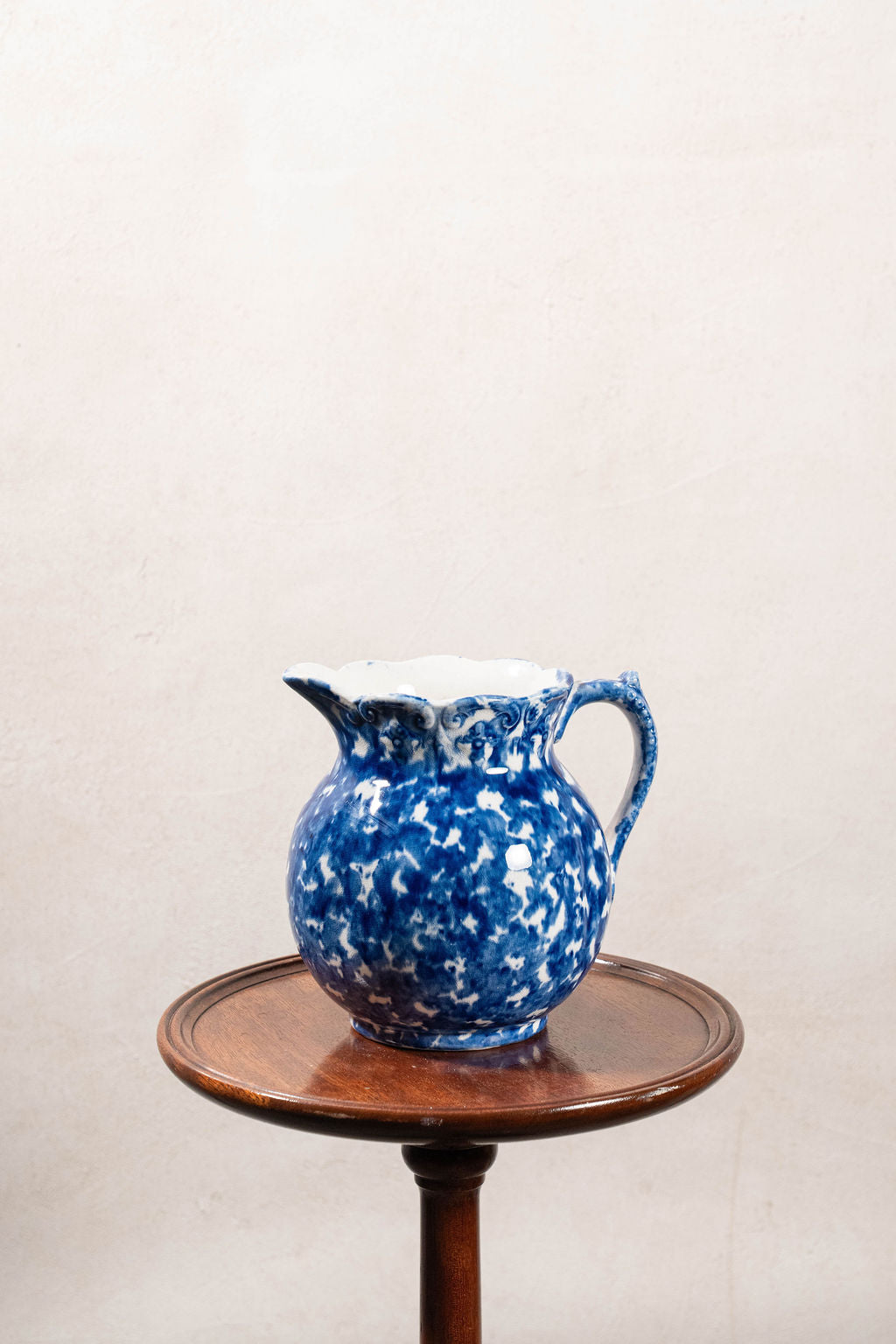 Antique Bulbous Blue Glazed Scalloped Spongeware Pitcher with Floral Relief Detail