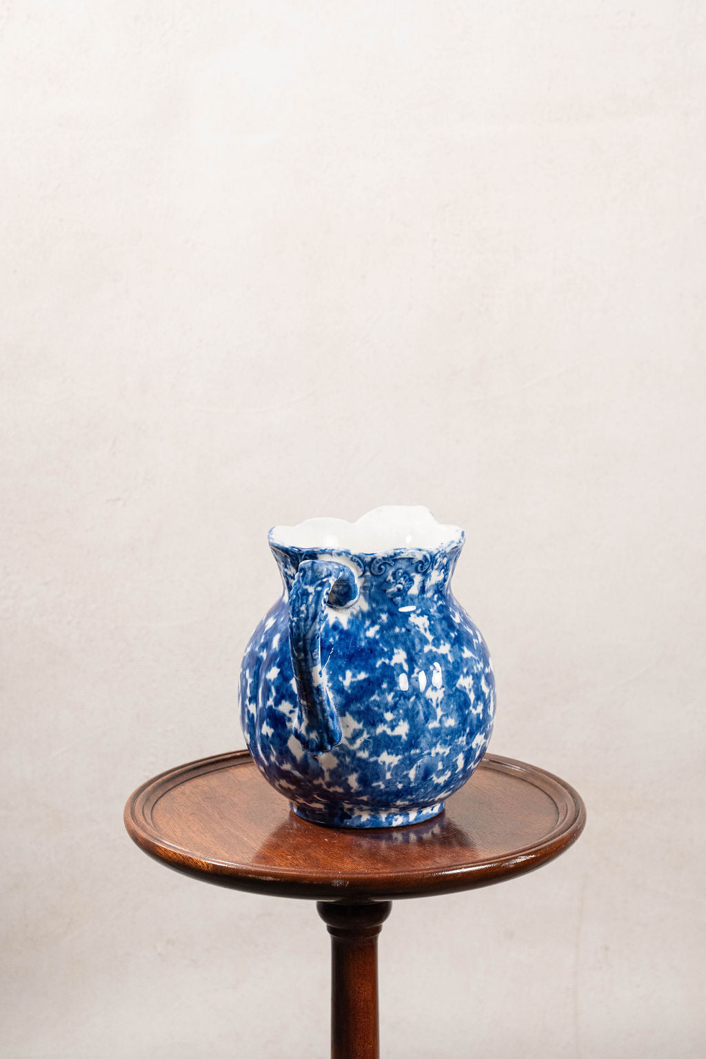 Antique Bulbous Blue Glazed Scalloped Spongeware Pitcher with Floral Relief Detail