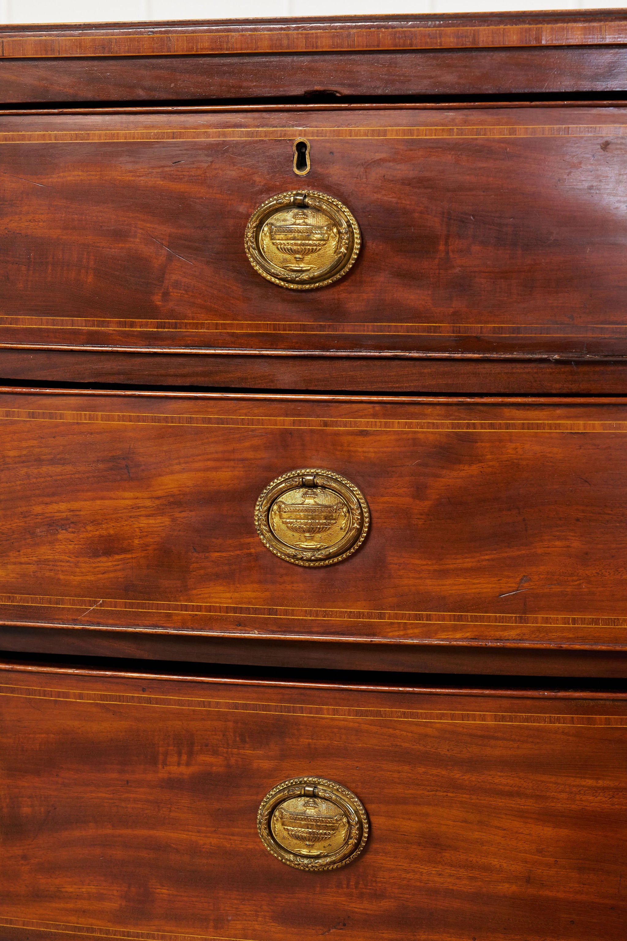 19th Century English Bowfront Chest with Urn Motif Oval Hardware