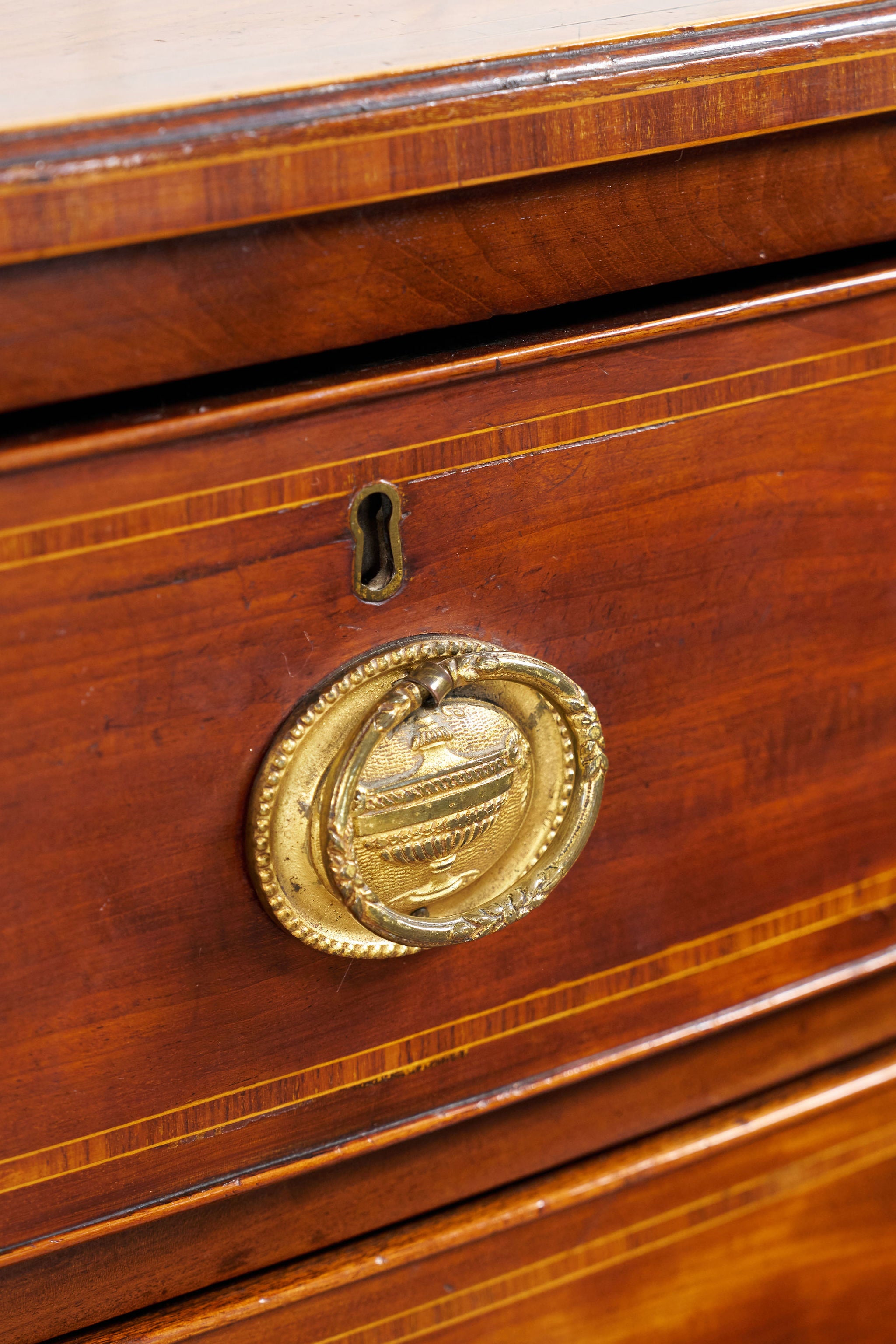 19th Century English Bowfront Chest with Urn Motif Oval Hardware