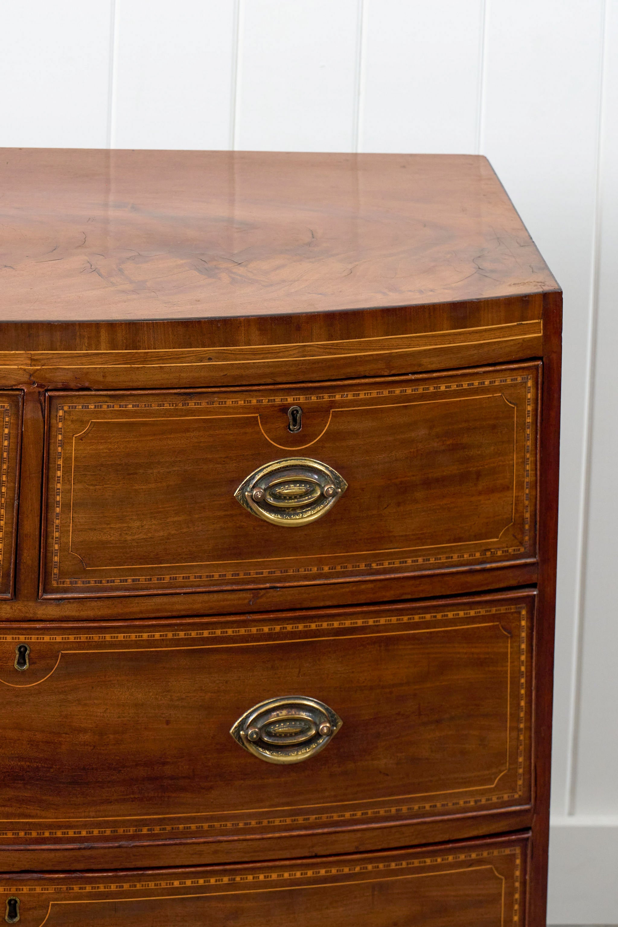 19th Century Mahogany Bowfront Chest with Satinwood Inlay on Splay Feet (c. 1810)
